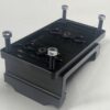 A Motor Mount from International Clamps, featuring a black metal bracket with four protruding bolts and multiple slots, is set against a plain white background. This model is the 8" width with a standard 1/2" plate.