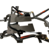 A close-up of the Junior Pedal Kits - Pursuit & Xpect 1" Rail, showcasing its metal frame with black panels, rods, and components that reveal intricate mechanical parts and connections. The frame features the word "BLACK" prominently displayed in orange.