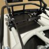 Close-up of a Foot Pan - For Elevate, Pursuit & Xpect CHAMP KART racing simulator pedal set with metal bars and mechanisms on a white surface in front of a beige background.