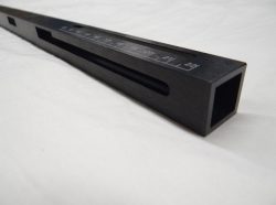 Rectangular black metal measuring instrument with engraved numerical markings from 19 to 23.