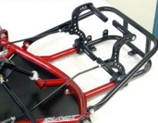 A close-up view of a red and black go-kart chassis frame, showing the metal framework and mounting brackets.